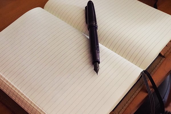 Image of fountain pen and journal